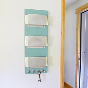 Mail holder mounted in the living room wall.